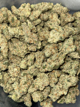 Close-up of fluffy Green Crack cannabis buds, showcasing vibrant green hues and orange pistils. Buy THCA flower online.