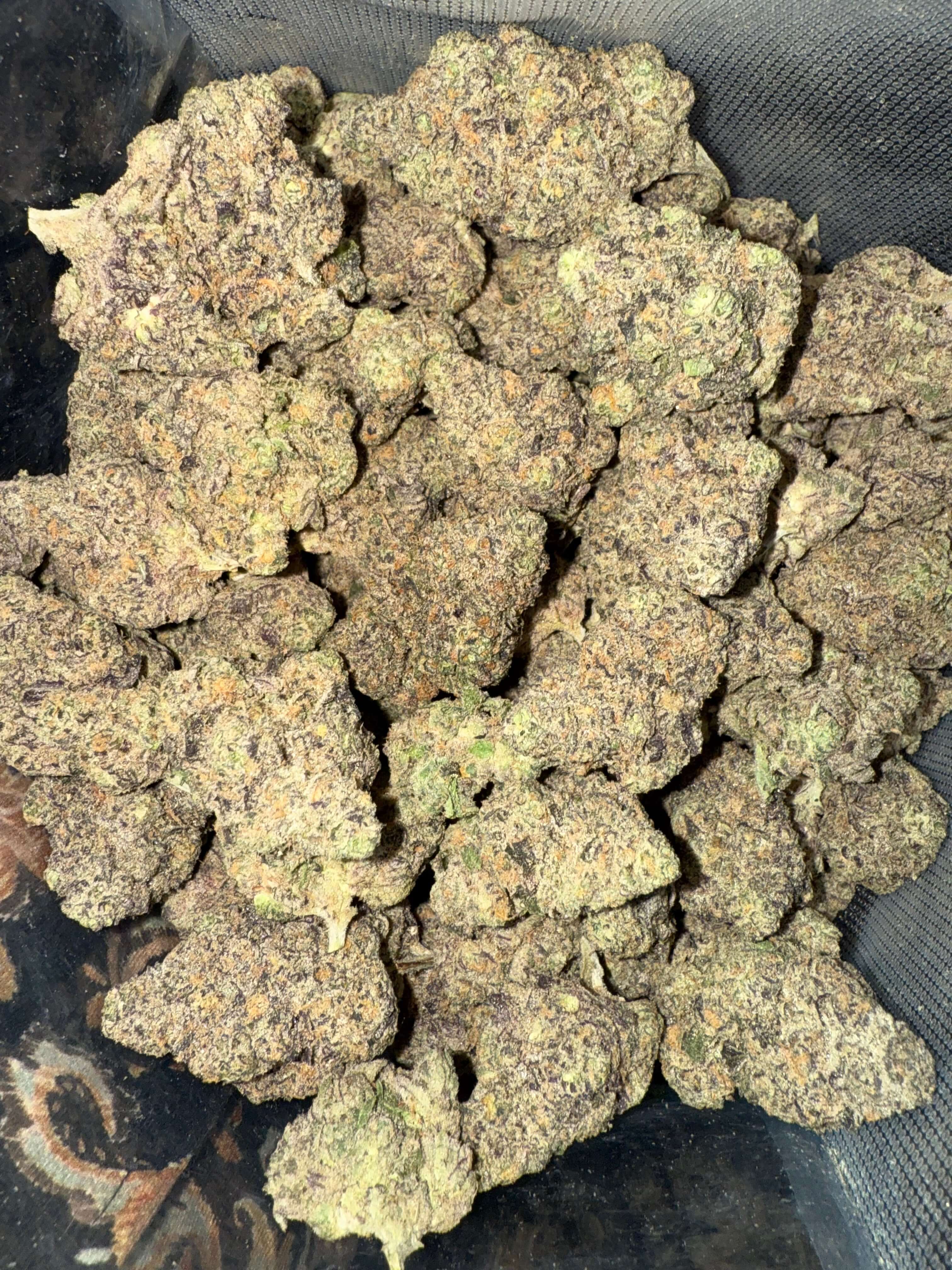 Gush Mintz cannabis buds showcasing dense purple and green hues, ideal for relaxation and creativity. Buy THCA flower online.